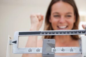 A licensed California medical provider using advanced body composition analysis to monitor a patient's lean muscle mass during a medical weight loss consultation.